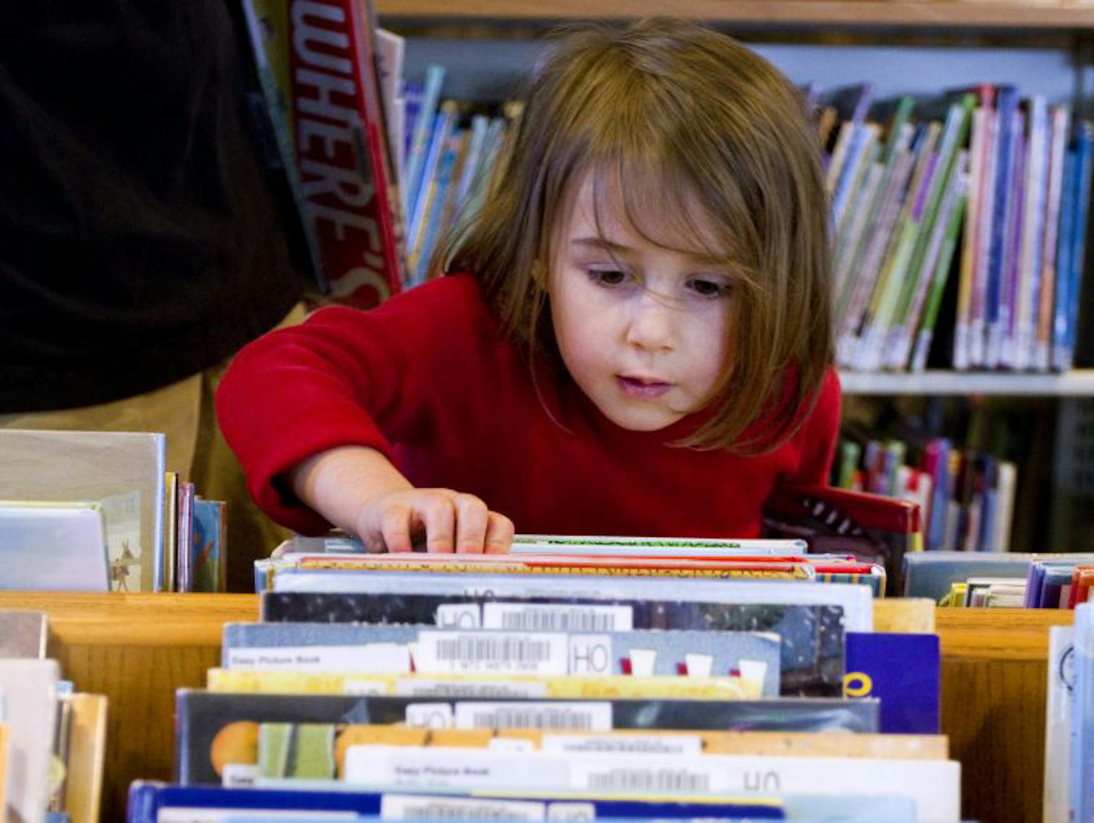 Lottie Ruch hunted for books in the children's sections at the Hopkins Library in May.