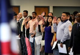 Ninety-four people took the oath of allegiance from Judge William J. Fisher and became new U.S. citizens during a naturalization ceremony on Wednesday