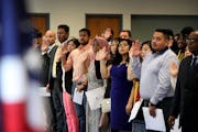 Ninety-four people took the oath of allegiance from Judge William J. Fisher and became new U.S. citizens during a naturalization ceremony on Wednesday