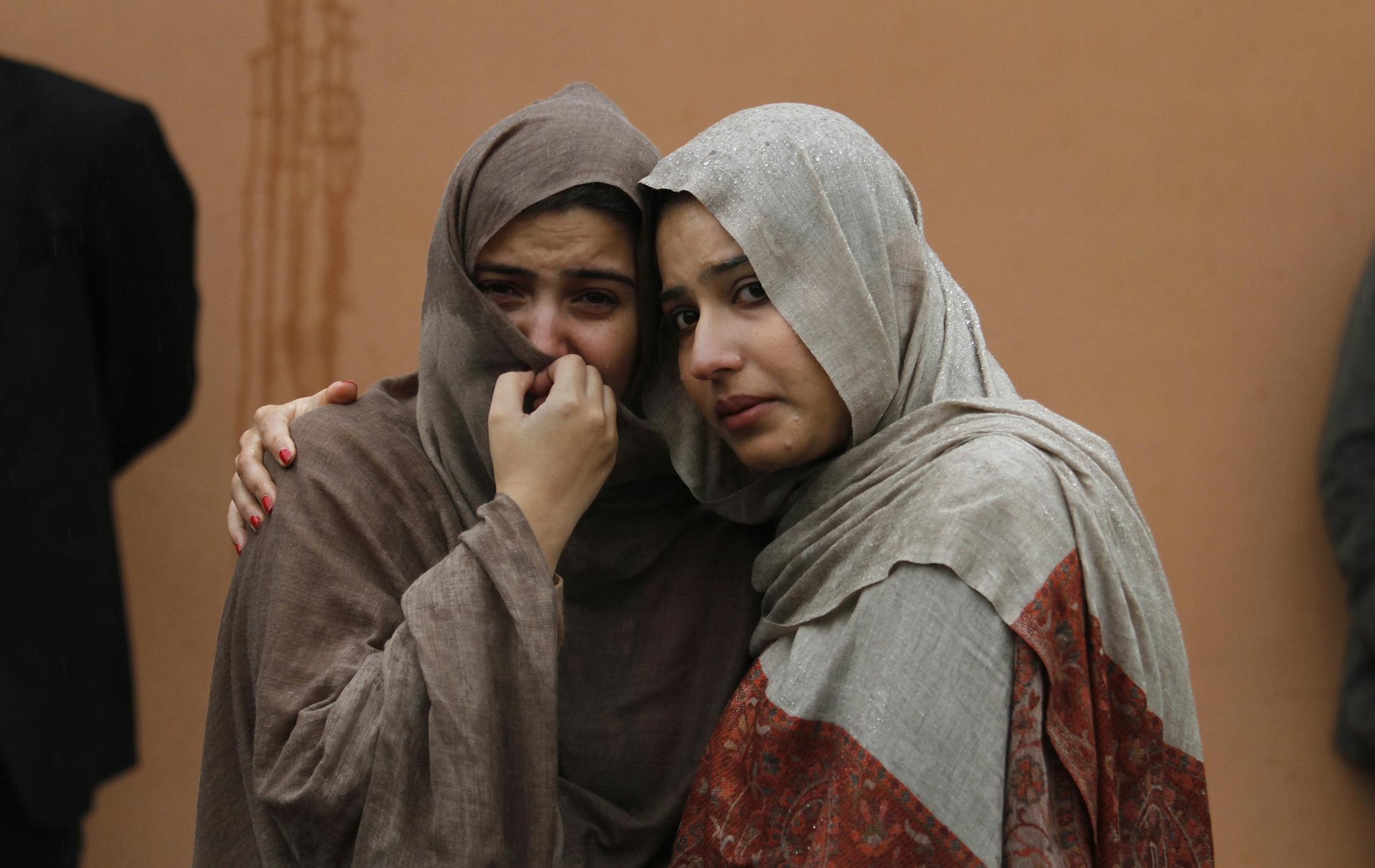 Relatives and others gathered outside a hospital’s morgue, where the bodies of victims of a suicide bombing were taken on Monday. Two bombers blew themselves up at a court complex in the Pakistani capital; at least 25 were wounded.