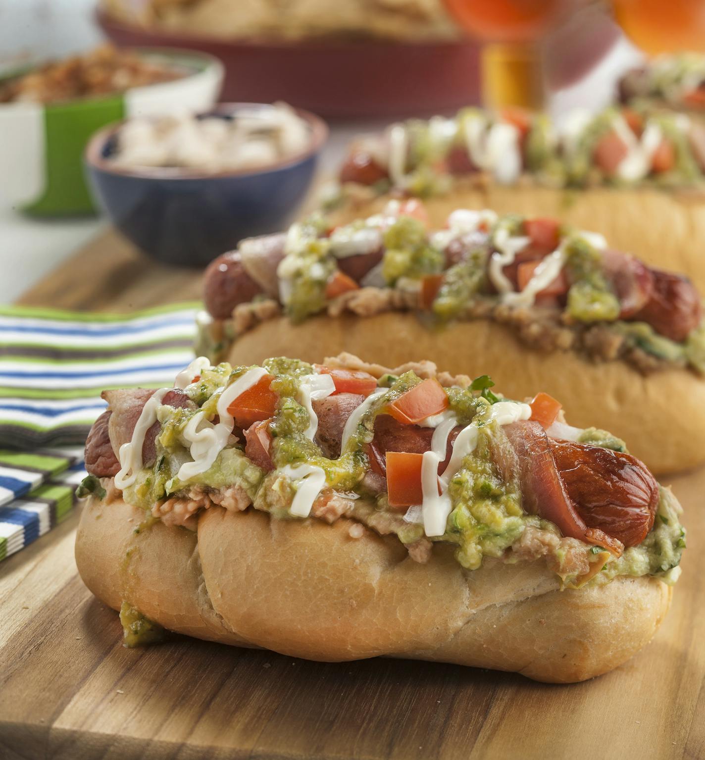 The Sonoran hot dog has a complex architecture, built with bacon, guacamole, refried beans, cheese, onion, tomato, salsa and mayo. (Bill Hogan/Chicago Tribune/TNS) ORG XMIT: 1162955