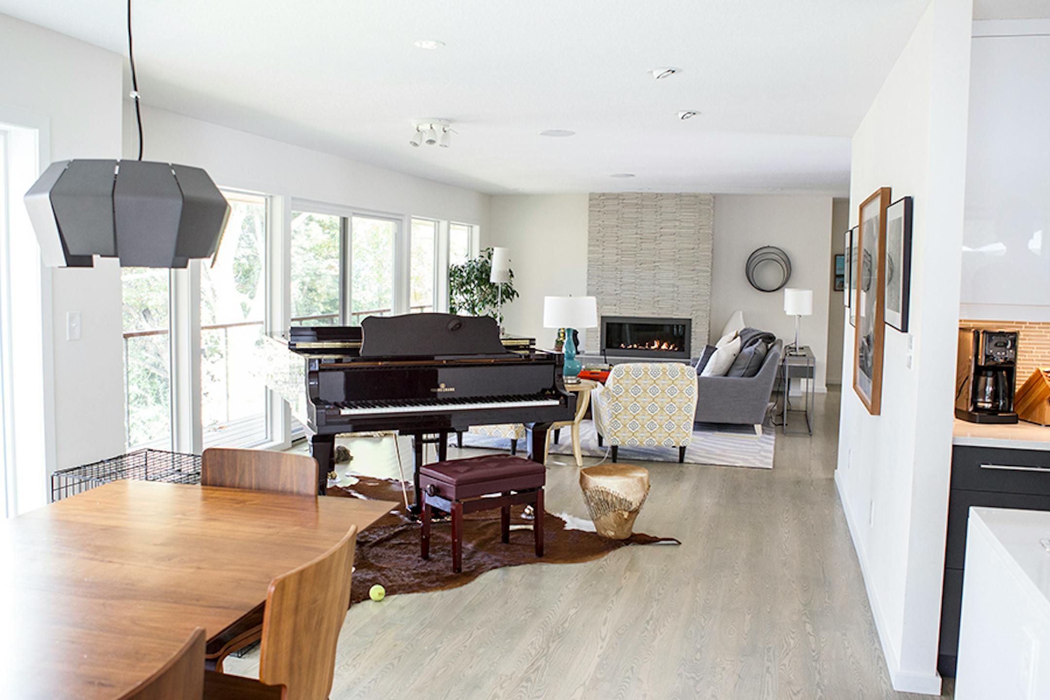 The modern home's open floor plan allows unobstructed views of the back-yard pond.