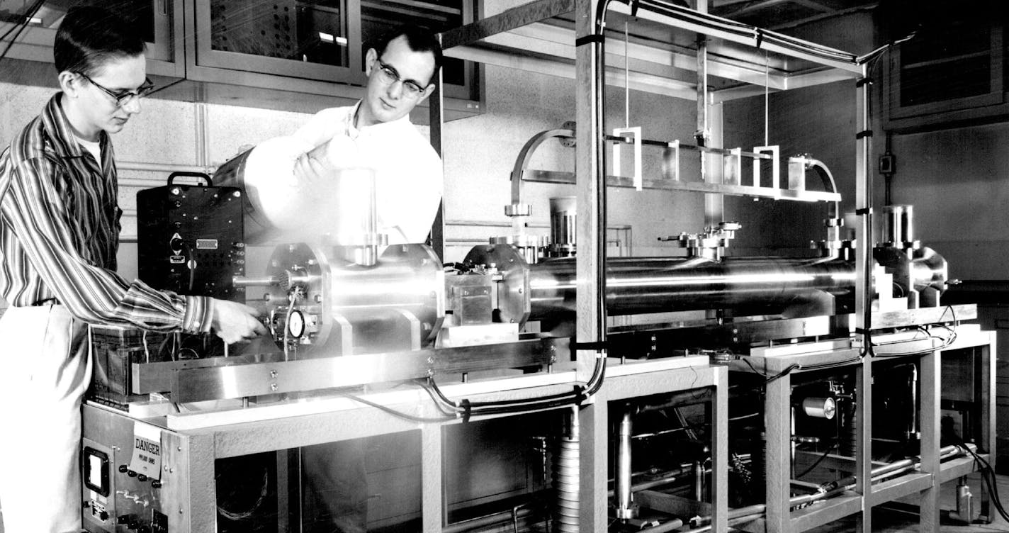 December 30, 1962 Scientists at the National Bureau of Standards laboratory at Boulder, Colo., have constructed an atomic clock to develop time measurement to the finest accuracy ever achieved. The clock, shown above, counts vibrations of atoms of cesium, shown in the capsule at left before being put into an "oven" which will vaporize it. According to the clock, a second is 9,192,631,770 vibrations of the cesium atoms. Minneapolis Star Tribune