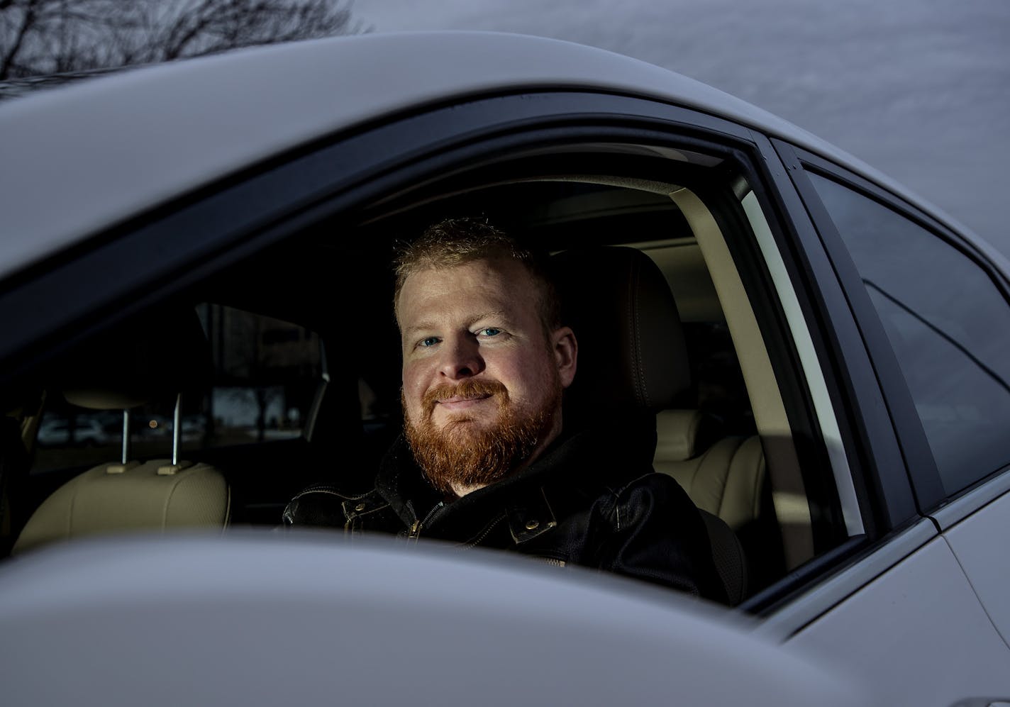 Zach Bohlman photographed in the car he uses to drive for Uber and Lyft. ] CARLOS GONZALEZ &#x2022; cgonzalez@startribune.com &#x2013; January 21, 2018, Edina, MN,
Zach Bohlman has a full-time job. When he wanted a "summer toy" (a used Corvette), he got gig work driving for Uber and Lyft. Now he's saving up for vacations with his wife.