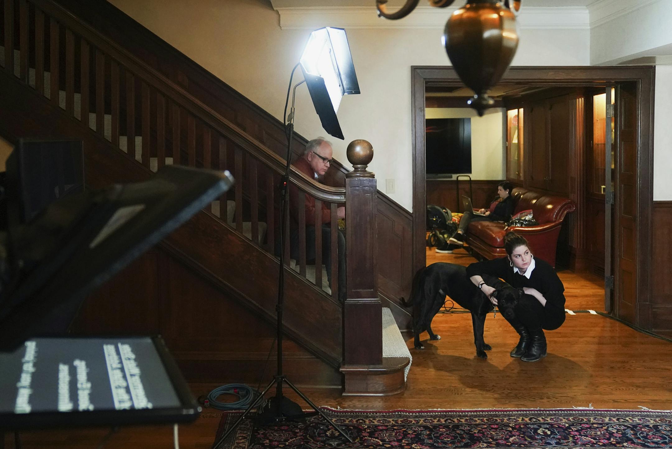 Minnesota Gov. Tim Walz, center, talks with communications director Kayla Castaneda, before the State of the State address over YouTube from his residence in St. Paul, Minn., Sunday, April 5, 2020. (Glen Stubbe/Star Tribune via AP, Pool)