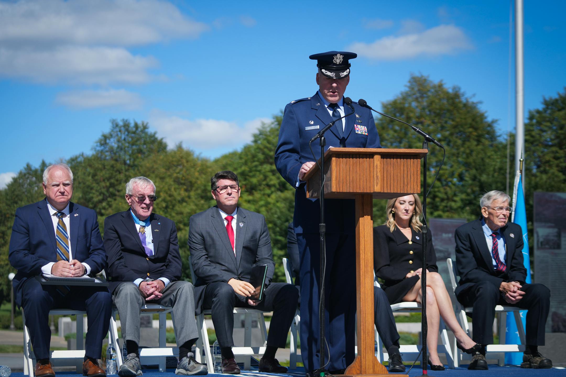 While Air Force Reserve Col. Roger Randy Stoeckmann spoke, from left, Minnesota Gov. Tim Walz, Tom Kelly, Mike McElhiney, Tiffany Kovaleski and John Kraemer listened.