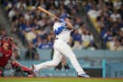 Los Angeles Dodgers' Max Muncy (13) singles during the fifth inning of a baseball game against the Minnesota Twins in Los Angeles, Monday, May 15, 202