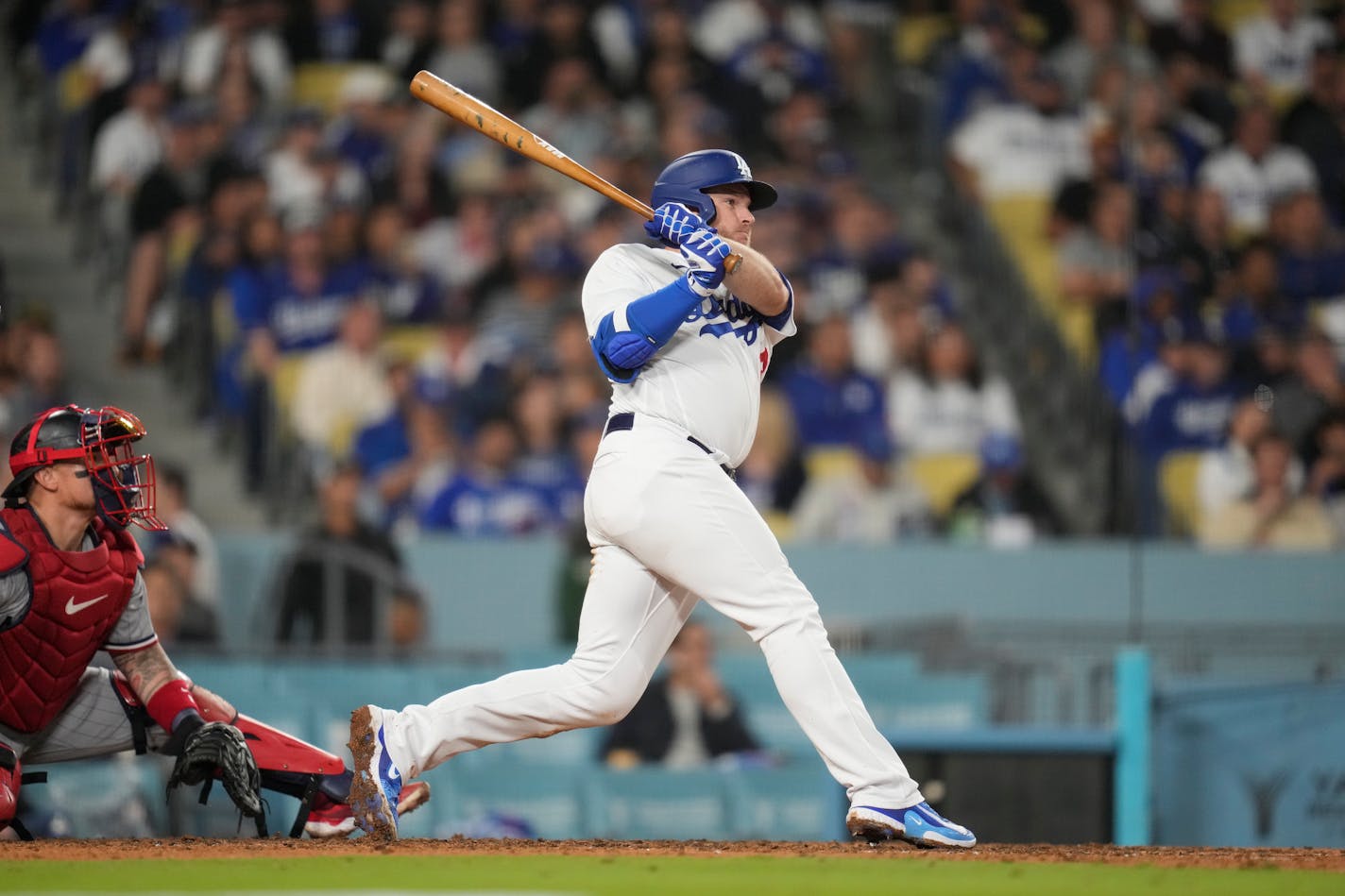 Los Angeles Dodgers' Max Muncy (13) singles during the fifth inning of a baseball game against the Minnesota Twins in Los Angeles, Monday, May 15, 2023. (AP Photo/Ashley Landis)