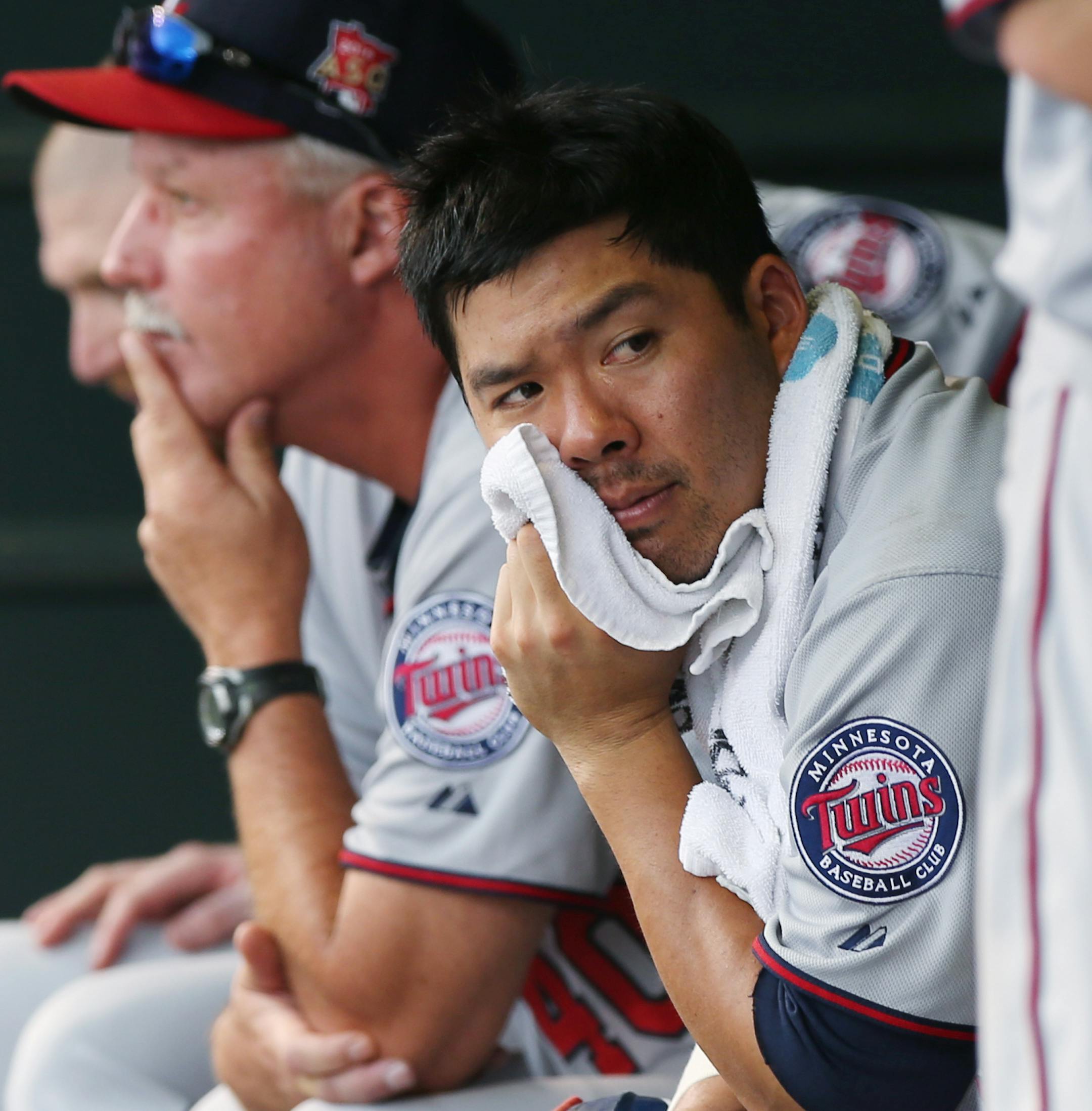 Minnesota Twins catcher Kurt Suzuki looks on from dugout against the Colorado Rockies in the eighth inning of the Twins' 13-5 victory in an interleague baseball game in Denver on Sunday, July 13, 2014. (AP Photo/David Zalubowski) ORG XMIT: MIN2014072521532263