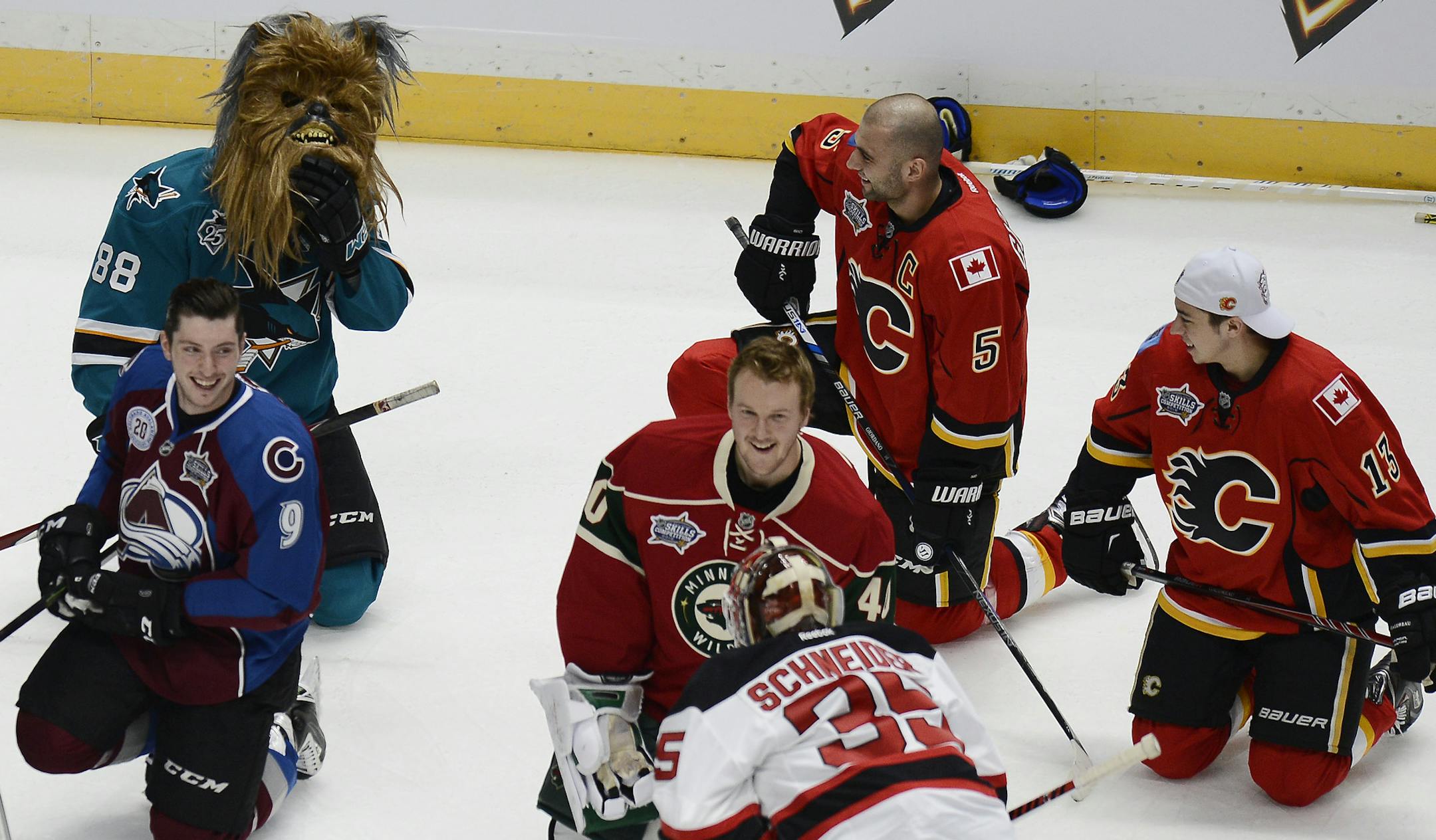 San Jose Sharks defenseman Brent Burns, top left, wearing a Star Wars Chewbacca mask, takes a break after participating in the breakaway challenge competition at the NHL All-Star skills competition Saturday, Jan. 30, 2016, in Nashville, Tenn. (AP Photo/Mark Zaleski)