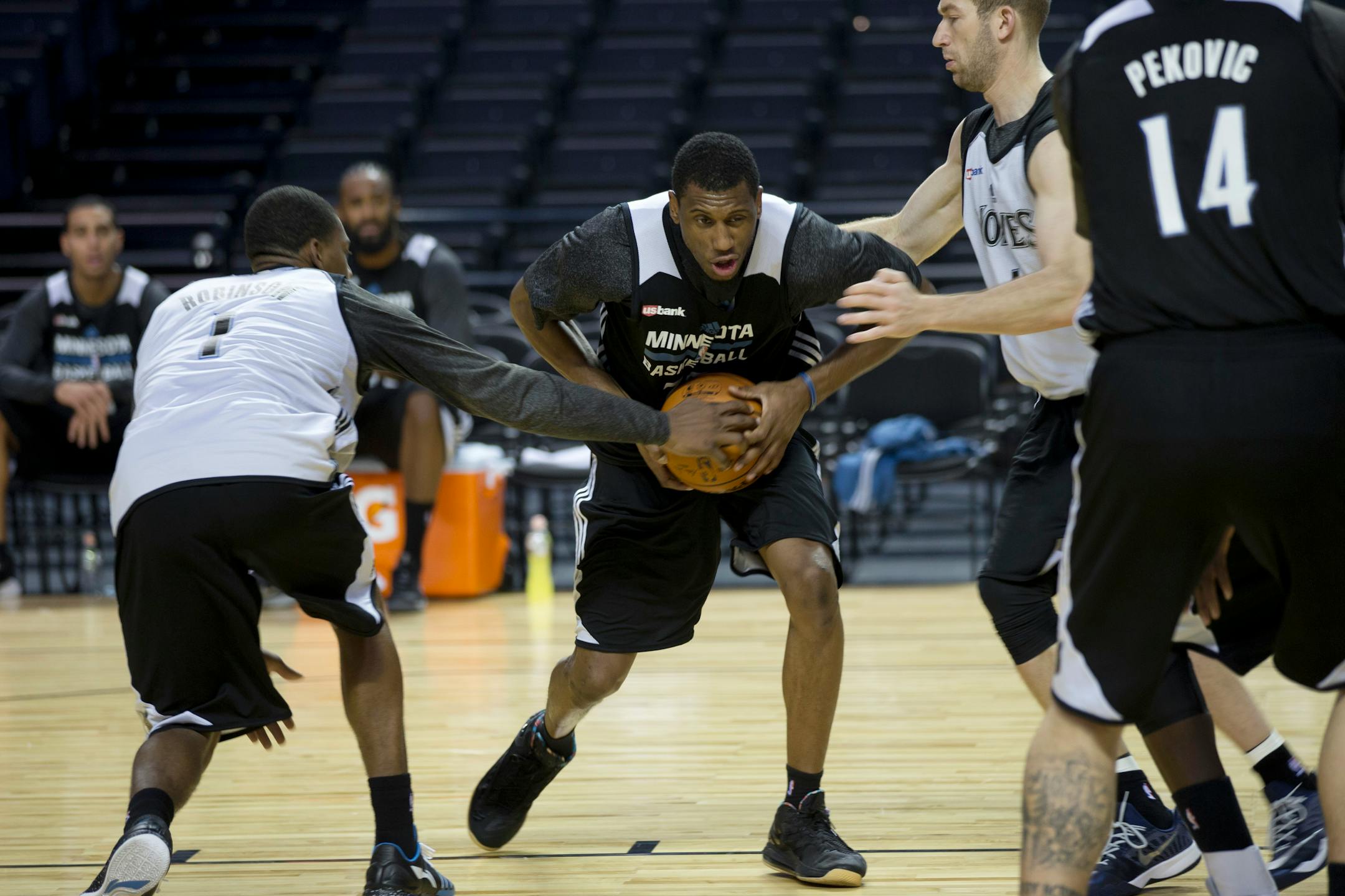 Thaddeus Young, center, of the Minnesota Timberwolves, tries to move past teammates during training at the Arena Ciudad de Mexico in Mexico City, Tuesday, Nov. 11, 2014.
