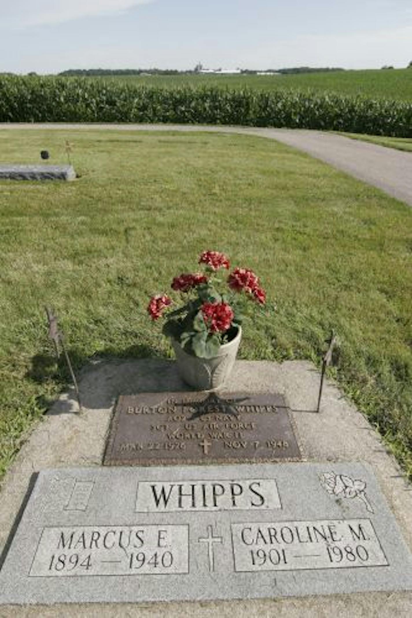 The grave of Marcus Whipps, one of three state game wardens murdered in 1940 in Waterville, Minn., lies in a small well-manicured cemetery surrounded by corn fields near LeCenter, Minn.