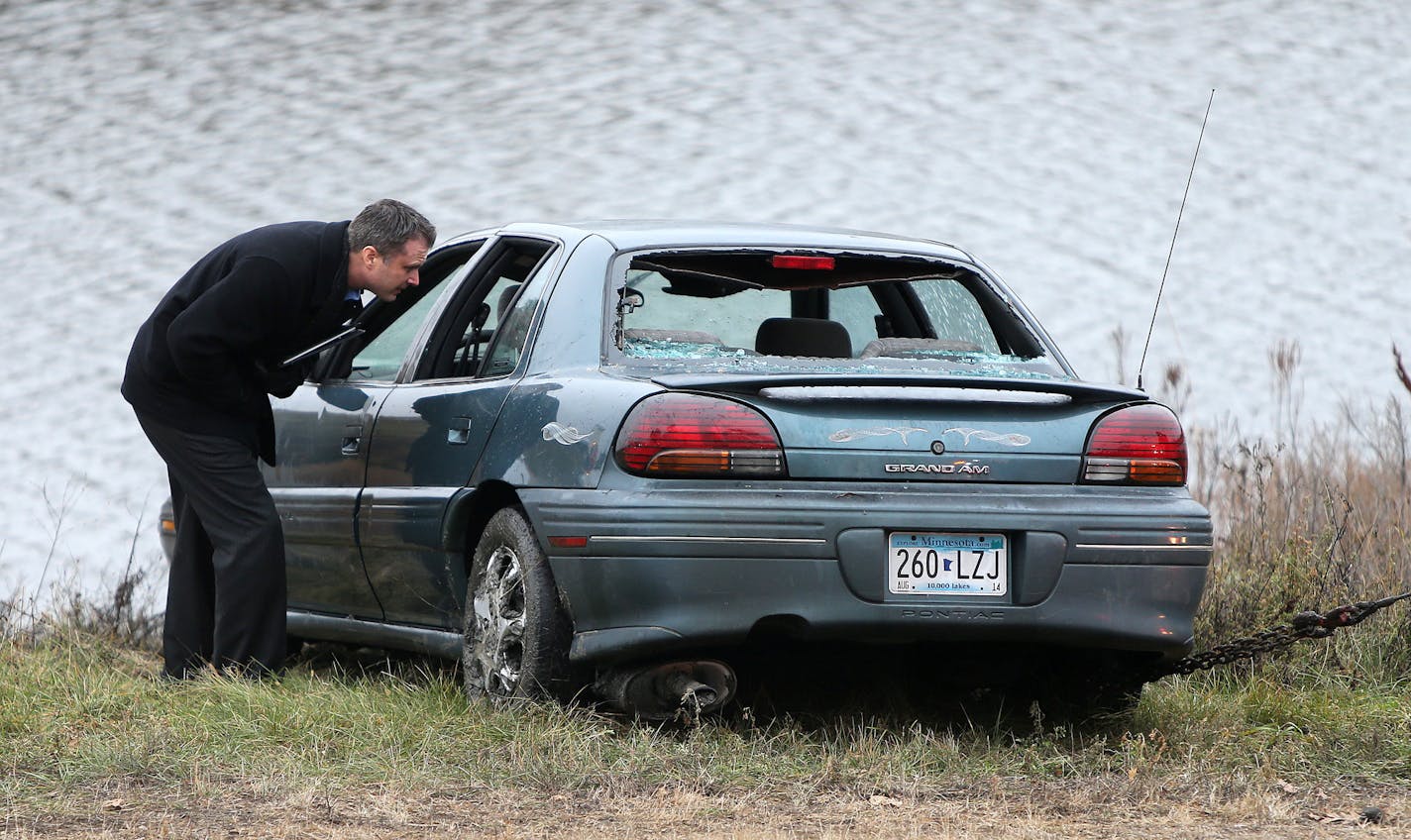 Police investigated the scene where six people were in a car that went into a holding pond near the Hwy 100 exit ramp going northbound on Hwy 7, Thursday, Nov. 21, 2013, in St. Louis Park.