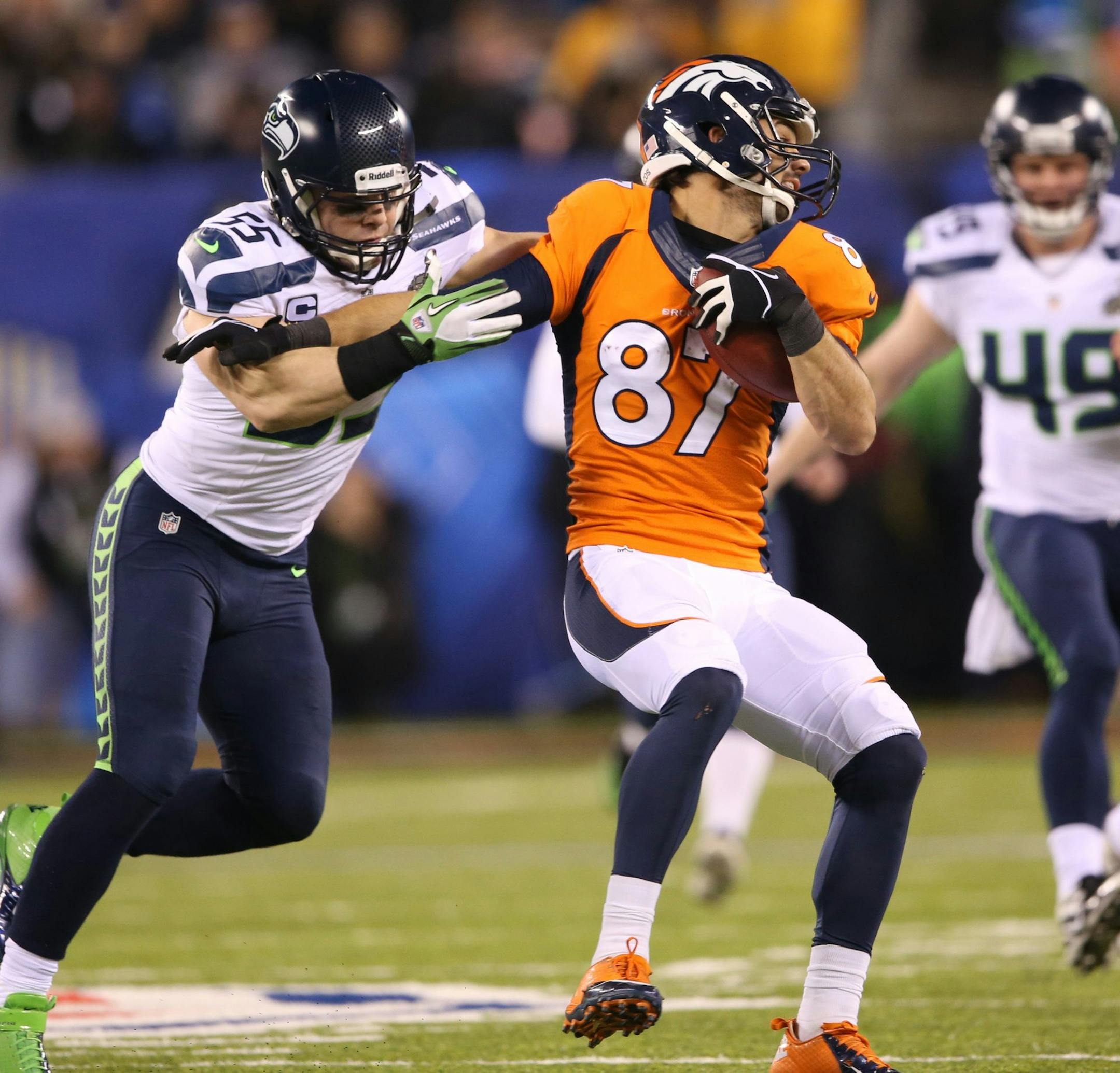 Eric Decker (87) of the Denver Broncos is tackled by Heath Farwell (55) of the Seattle Seahawks during the second half of Super Bowl XLVIII at MetLife Stadium in East Rutherford, N.J., on Sunday, Feb. 2, 2014. (Lionel Hahn/Abaca Press/MCT)