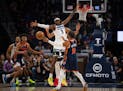 Minnesota Timberwolves forward Jaden McDaniels (3) defended a pass by New York Knicks guard Jalen Brunson (11) in the first quarter.
