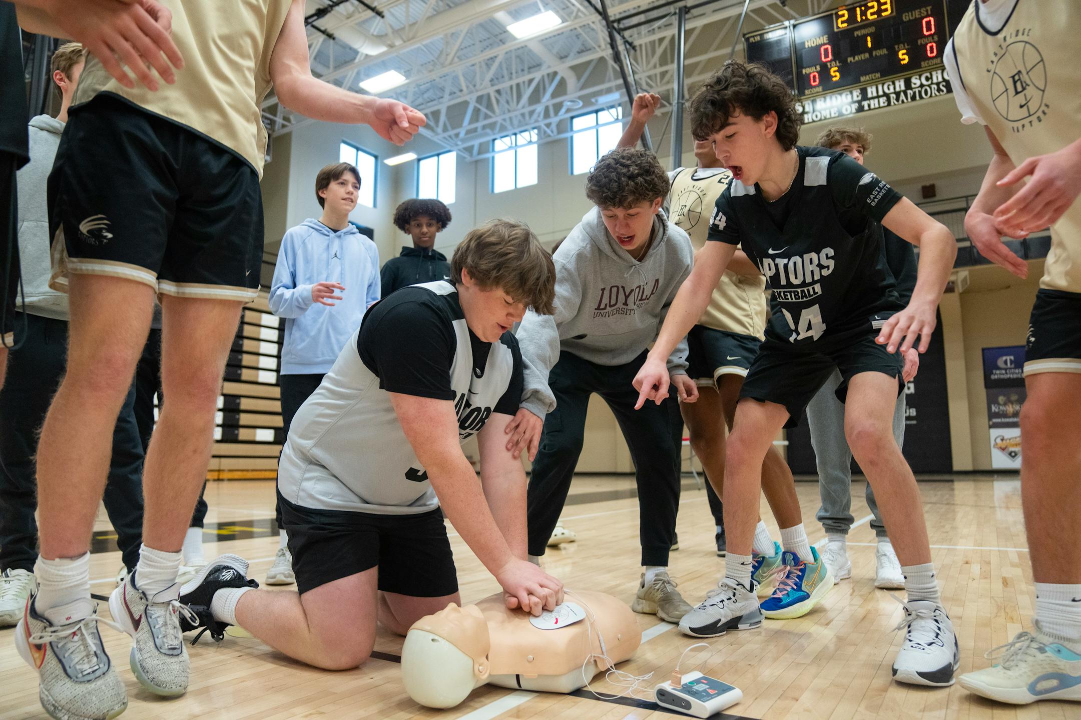 East Ridge basketball players cheer on Riley Hall as they compete with their teammates to properly use a test AED on a CPR mannequin Wednesday, Feb. 07, 2024, at East Ridge High School in Woodbury, Minn. The Cottage Grove Fire Department and the Teddy's Heart Foundation lead the workshop. Teddy’s Heart Foundation is a Cottage Grove nonprofit run by the family of Teddy Dowdle, who collapsed and died of a heart attack in 2022 while playing basketball. His family has made it their mission to post AED devices in public places and teach people how to use them, believing they will save lives.    ]

ALEX KORMANN • alex.kormann@startribune.com