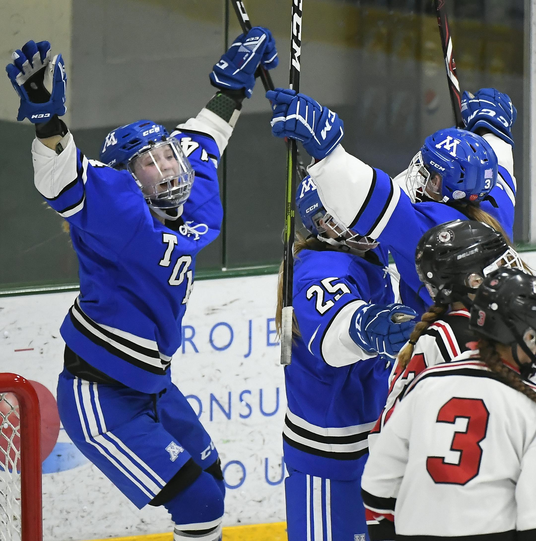 From left, Minnetonka defenseman Maggie Nicholson (14), forward Molly McHugh (25) and forward Kate Hoelscher (3) celebrated a goal by Hoelscher seconds in the the second period Friday against Eden Prairie. ] Aaron Lavinsky ¥ aaron.lavinsky@startribune.com Eden Prairie played Minnetonka in the Class 2A, Section 2 girls' hockey final on Friday, Feb. 15, 2019 at Braemar Arena in Edina, Minn.
