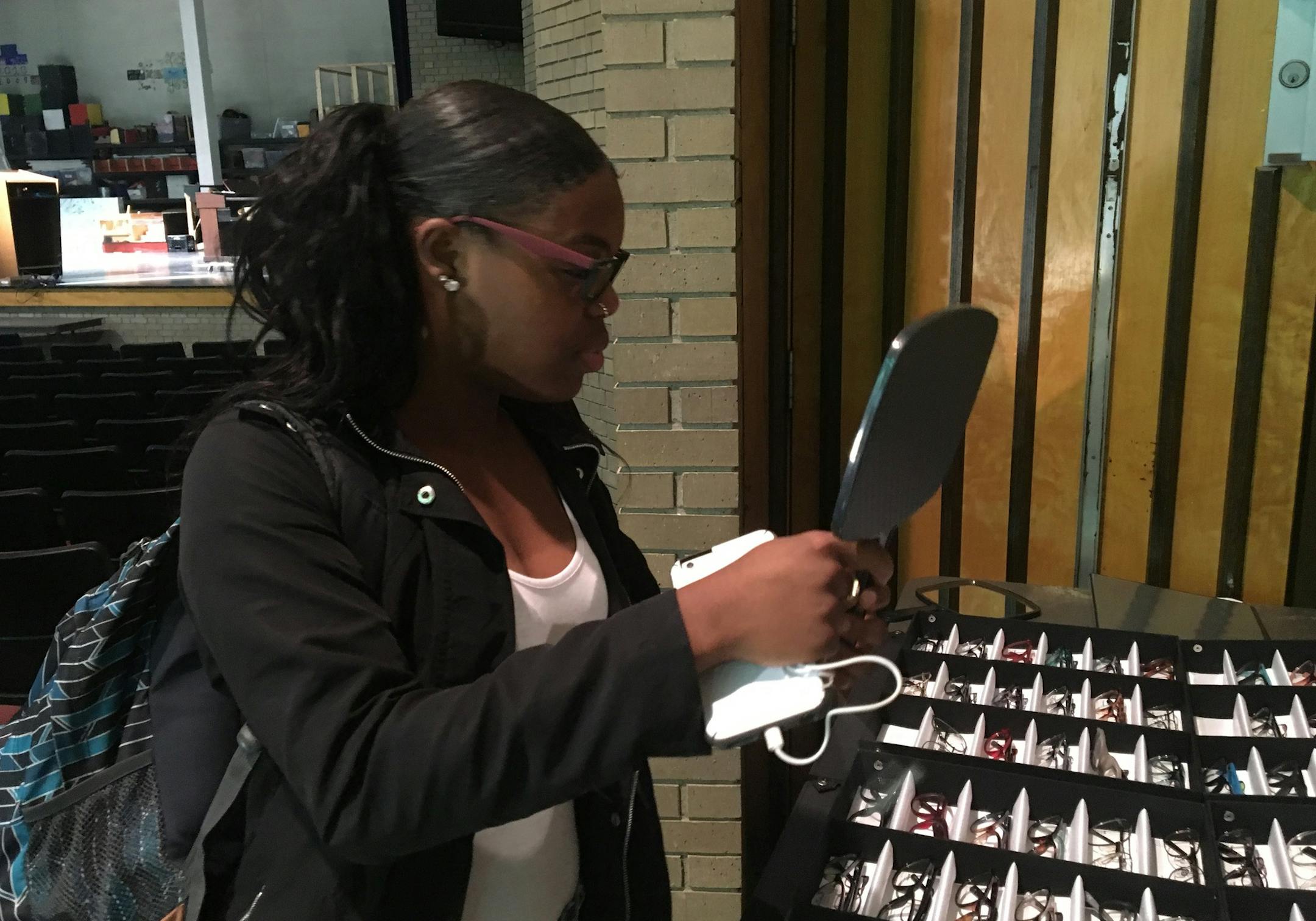 At top, optometrist Meredith Walburg examined Denae Whitfield, a student at Harding High School. Whitfield was one of 2,500 students who received a free vision screening from ChildSight Minnesota last fall. Of those, 670 students, including Whitfield, were found to have vision problems and got to choose a free pair of trendy glasses.