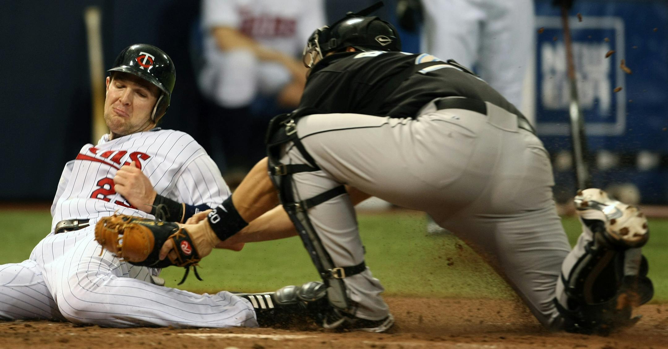 Toronto Blue Jays catcher Rod Barajas tags out Minnesota Twins' Brendan Harris, who tried to score on Justin Morneau's single in the fifth inning.