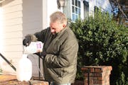 Mitch Vestal pours the product he developed, PlaySafe Ice Blocker, into a sprayer. The solution blocks ice from forming on driveways and sidewalks.
