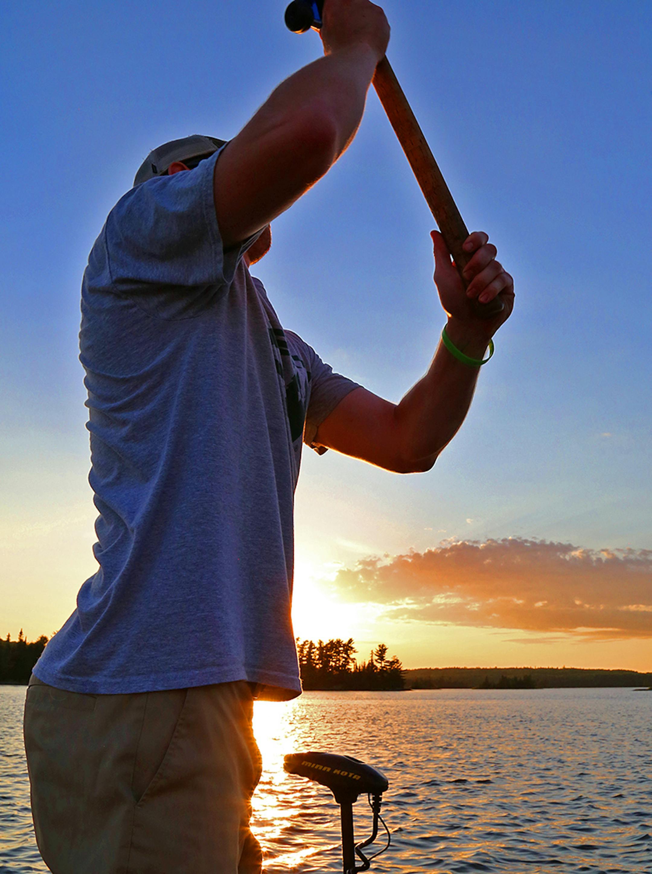 Dominic Schneider of Maplewood, a senior at the University of North Dakota, casts at sunset on Lake of the Woods while fishing for muskies.