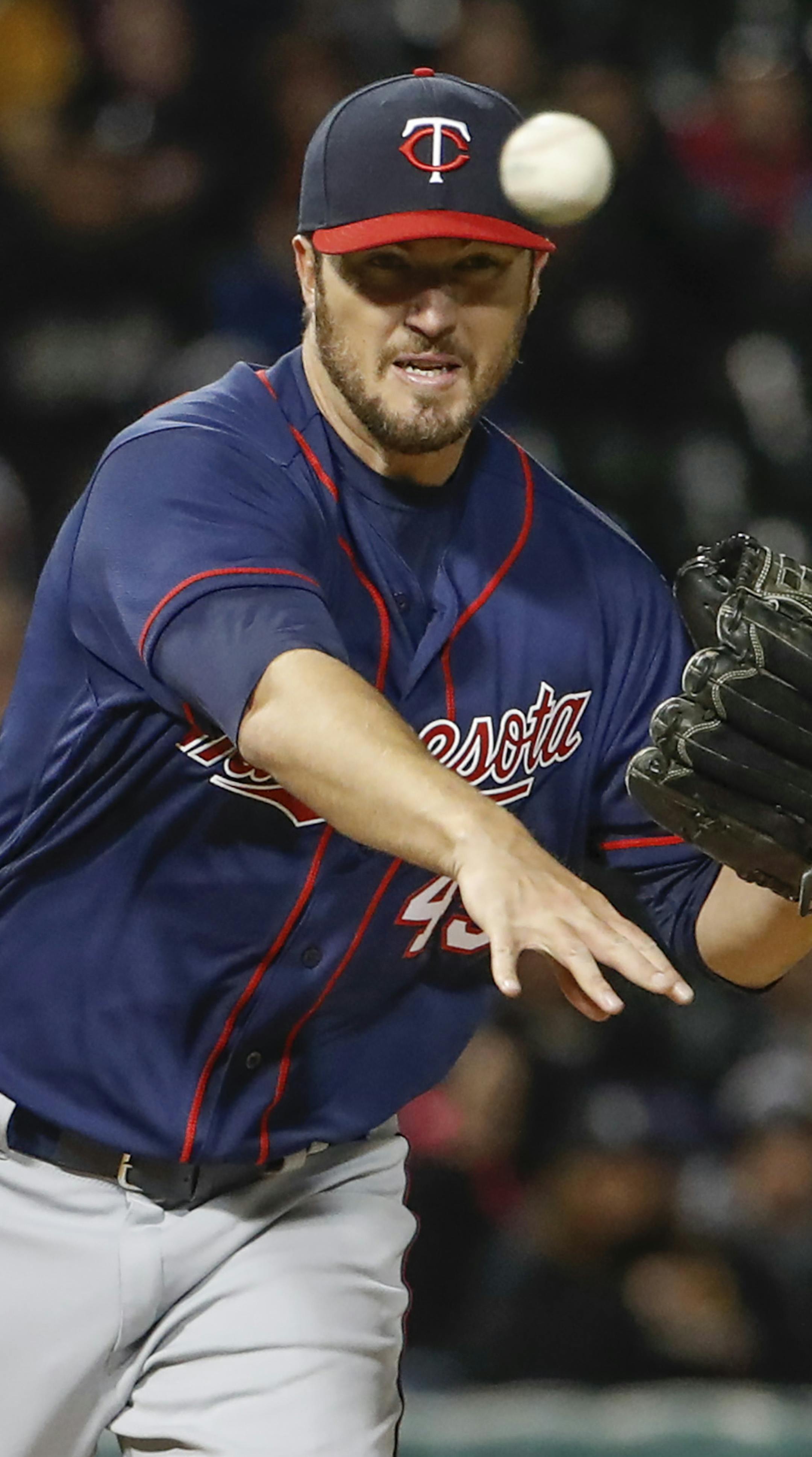 Minnesota Twins starting pitcher Phil Hughes throws to a first base during the fifth inning of a baseball game against the Chicago White Sox, Friday, April 7, 2017, in Chicago. (AP Photo/Kamil Krzaczynski)