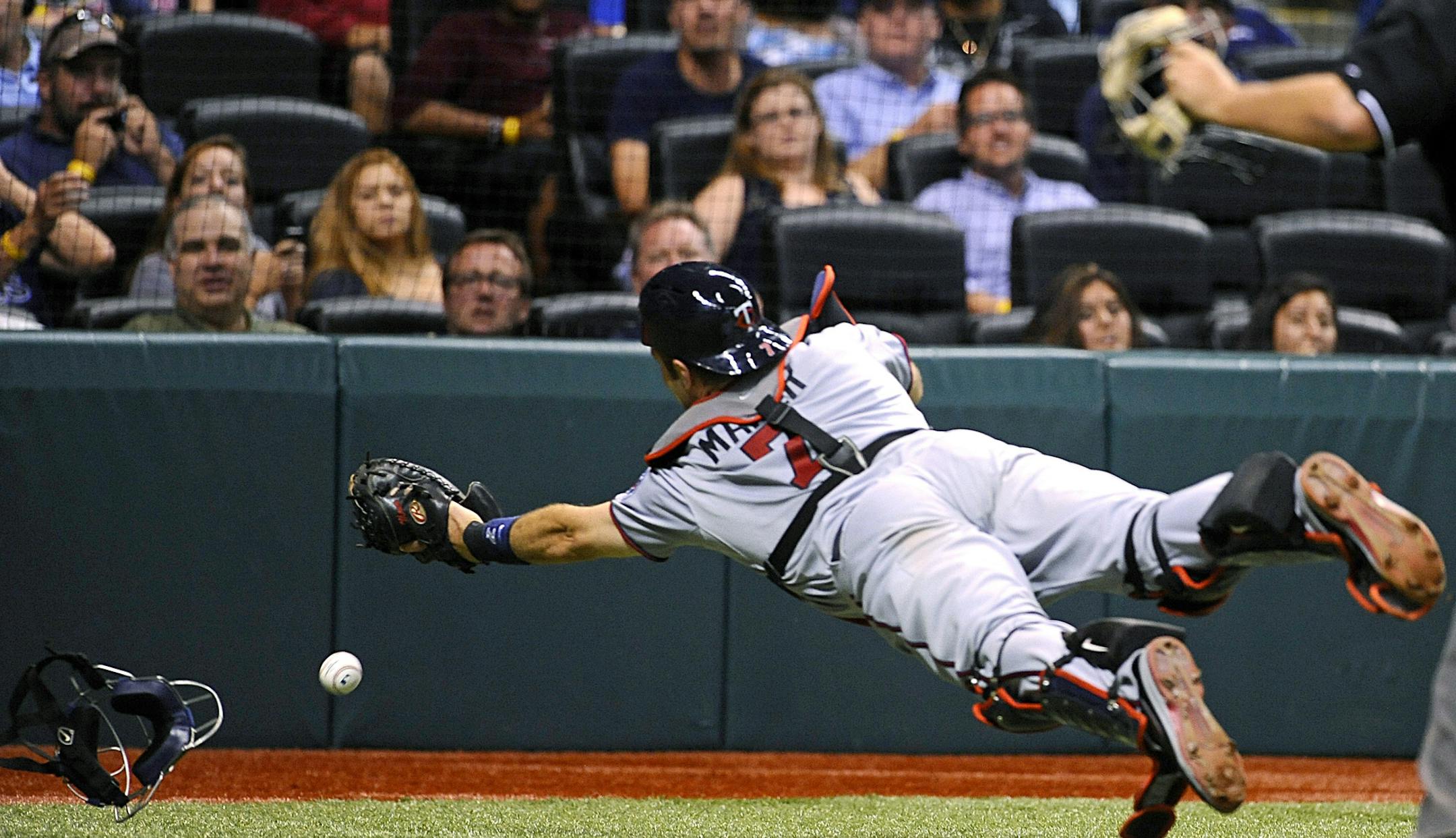 Minnesota Twins catcher Joe Mauer fails to haul in a foul ball hit by Tampa Bay Rays' Ben Zobrist during the eighth inning of a baseball game Tuesday, July 9, 2013, in St. Petersburg, Fla. The Rays won 4-1. (AP Photo/Brian Blanco)