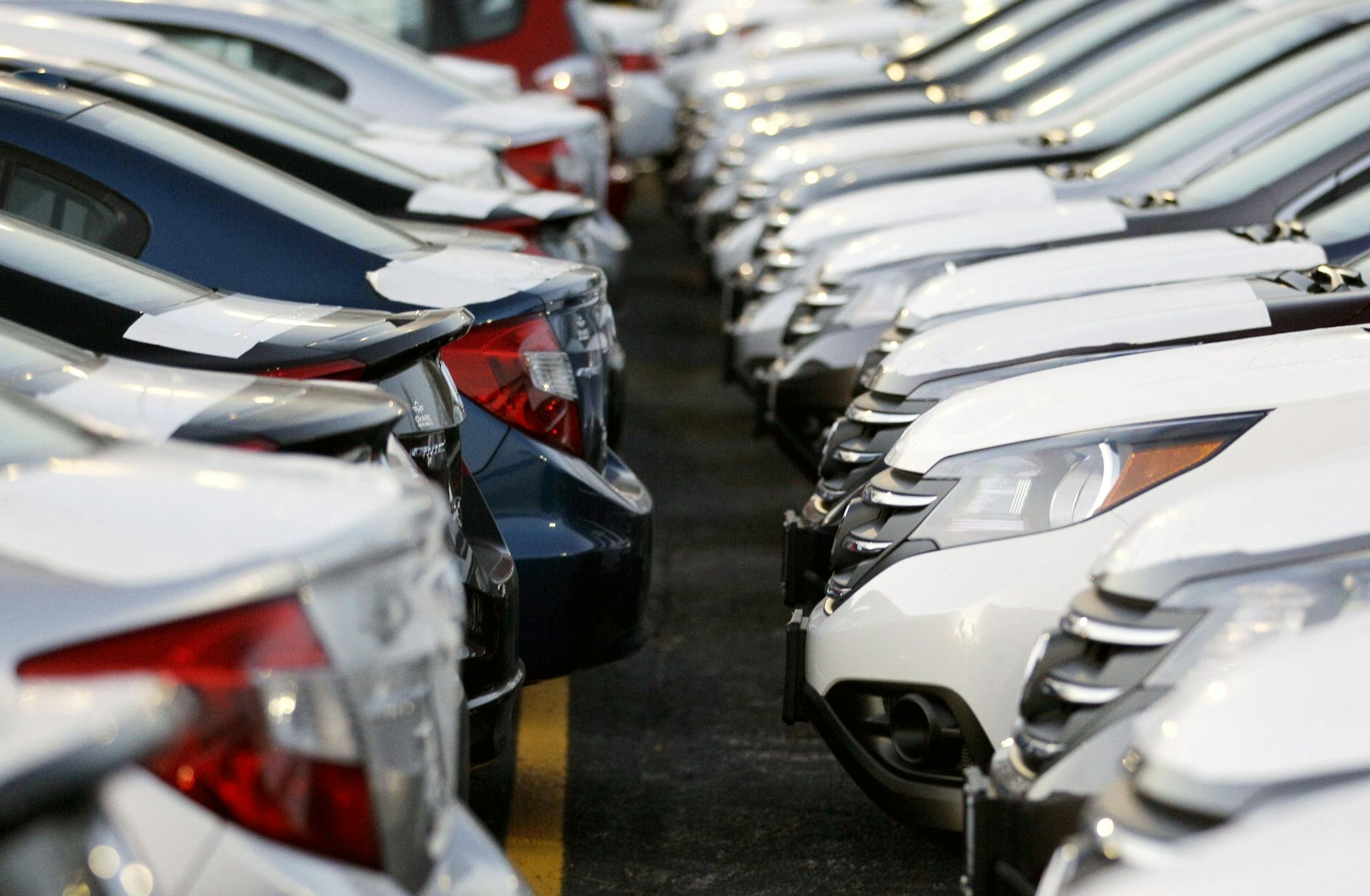 FILE - In this Wednesday, Dec. 5, 2012, file photo, Honda Civic and Honda CRVs are parked outside of a Honda car dealership in Des Plaines, Ill. Only the two-door and four-door Honda Civic models earned the top rating of ìgoodî in the front-end crash tests done by the Insurance Institute for Highway Safety, while the Dodge Dart, Ford Focus, Hyundai Elantra and the 2014 Scion tC got ìacceptableî ratings. (AP Photo/Nam Y. Huh, File)