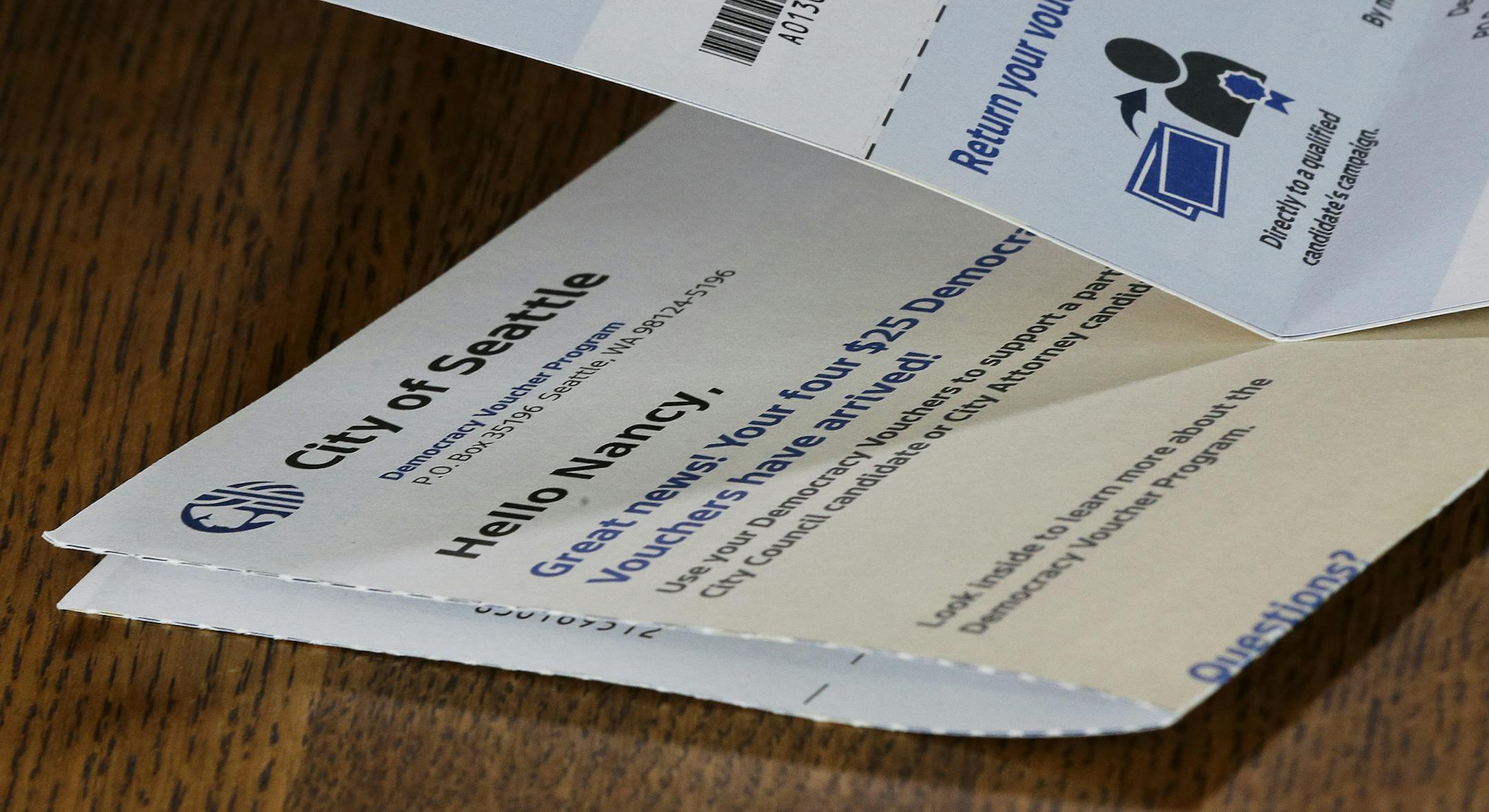 A City of Seattle Democracy Voucher belonging to the wife of Mark Elster rests on a table, Wednesday, June 28, 2017, in Seattle. Elster is a plaintiff in a new lawsuit challenging Seattle's first-in-the-nation voucher system for publicly financing political campaigns. (AP Photo/Ted S. Warren) ORG XMIT: WATW103