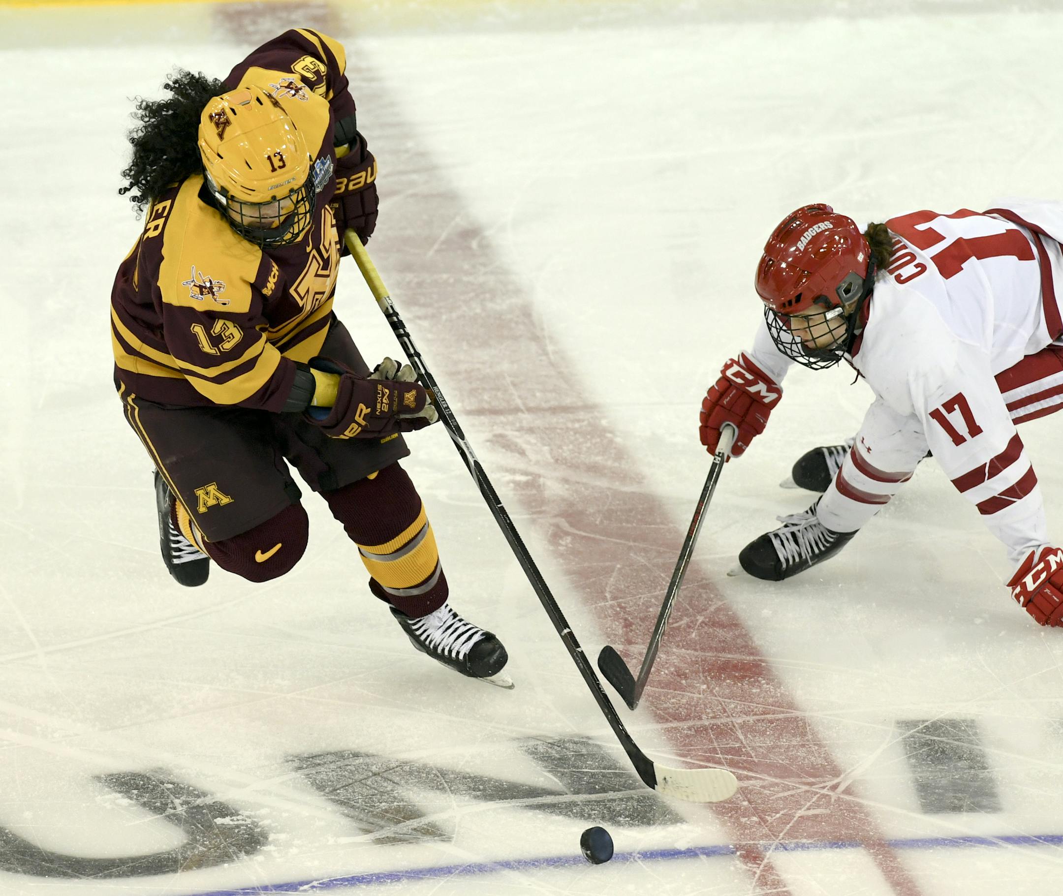 Minnesota's Crystalyn Hengler (13) and Wisconsin's Britta Curl (17) battle for the puck during the first period in the NCAA Division I women's Frozen Four hockey championship game, Sunday, March 24, 2019, in Hamden, Conn. (AP Photo/Stephen Dunn)