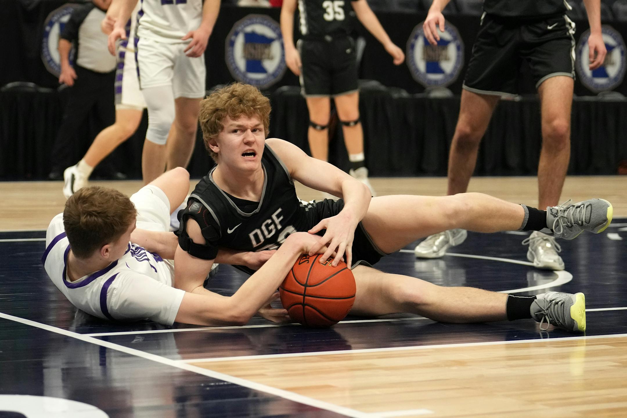 Albany forward Sam Hondl (23) and DGF forward Brody Friend (20) fight for a loose ball in the second half.