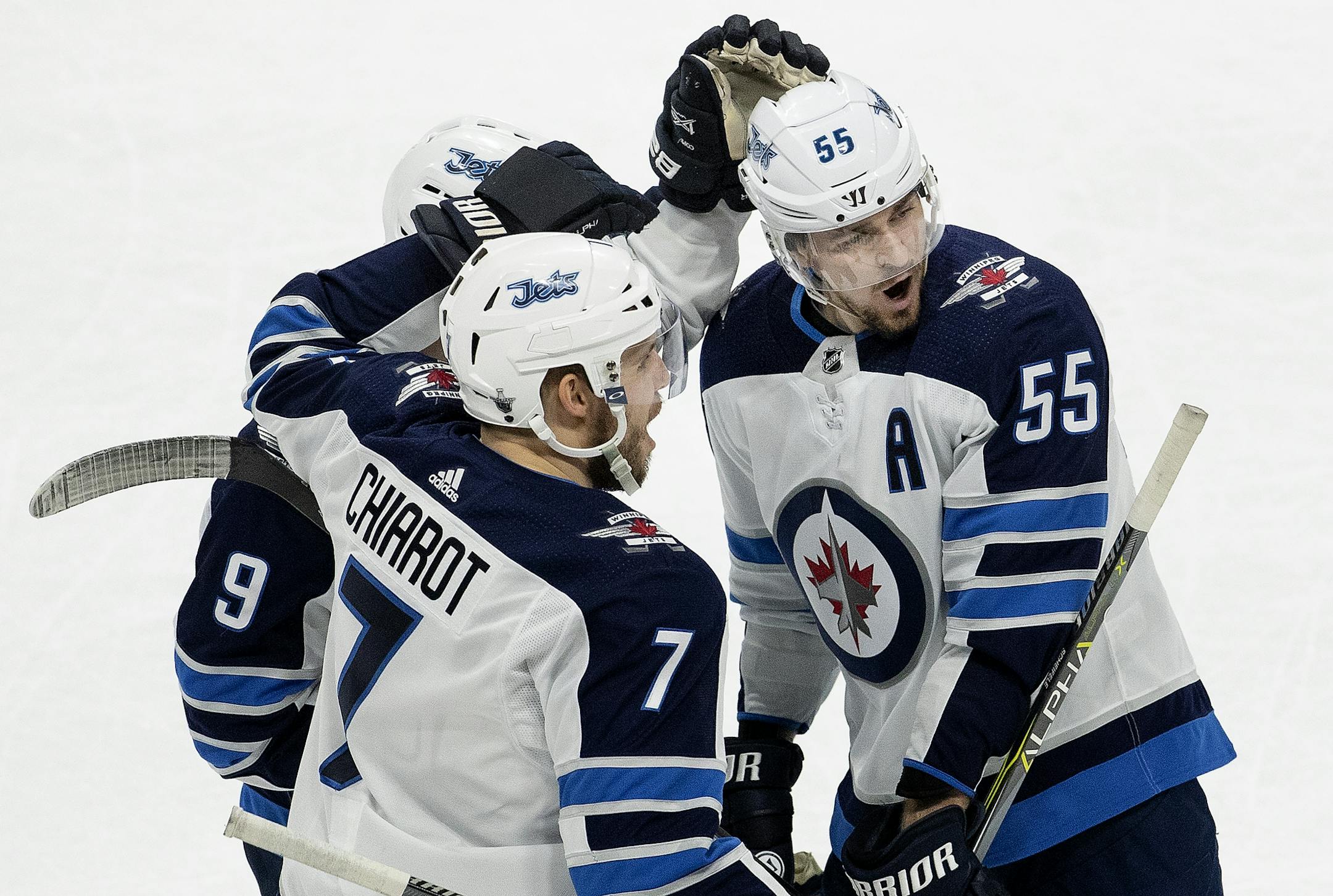 Mark Scheifele (55) celebrated with teammates after scoring an empty net goal in the third period.