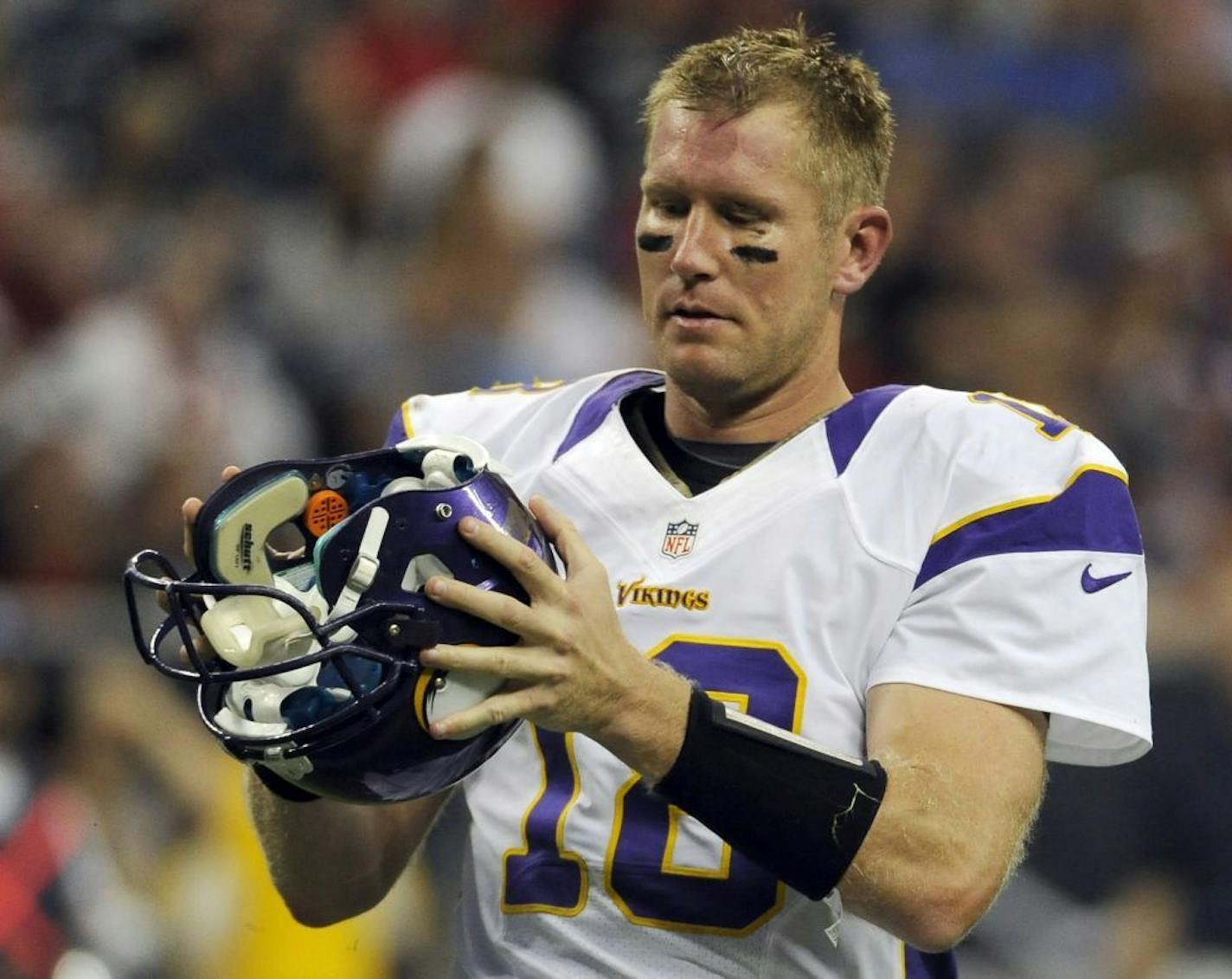 After looks over his helmet after losing it during a play against the Houston Texans, Minnesota Vikings quarterback Sage Rosenfels (18) during the first half of an NFL preseason football game, Thursday, Aug. 30, 2012, in Houston.