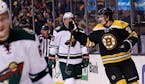 Boston Bruins left wing Loui Eriksson, right, skates past Minnesota Wild defenseman Ryan Suter, center, after scoring his first goal of the game durin