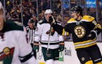 Boston Bruins left wing Loui Eriksson, right, skates past Minnesota Wild defenseman Ryan Suter, center, after scoring his first goal of the game durin
