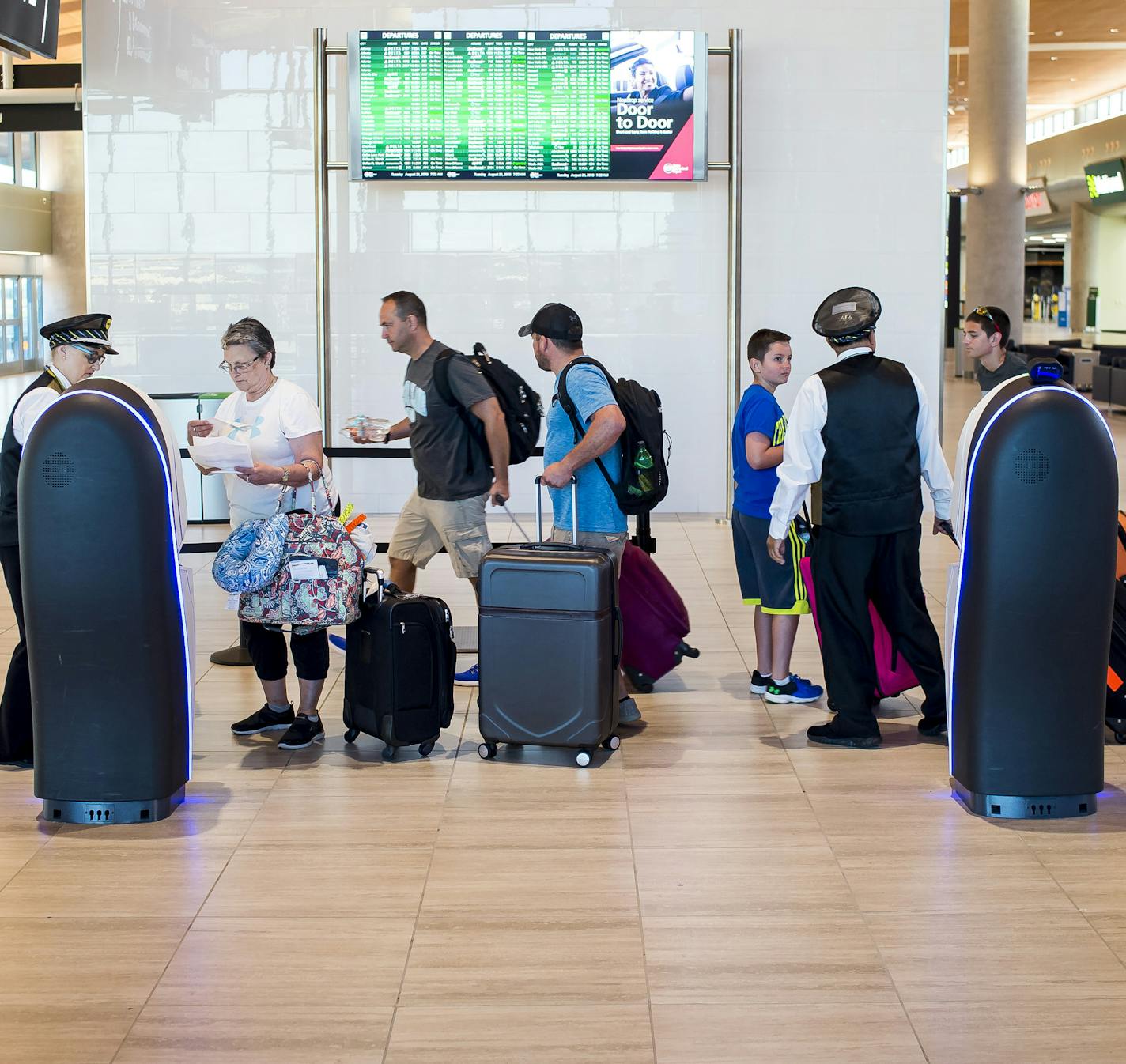 Travelers check bags at remote check-in terminals at Tampa International Airport in Tampa, Fla., Aug. 21, 2018. As carriers face higher fuel and labor costs, some are increasing their checked bag fee to $30 from $25. (Zack Wittman/The New York Times)