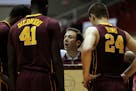 Minnesota university basketball coach Richard Pitino, center, talk to his players .