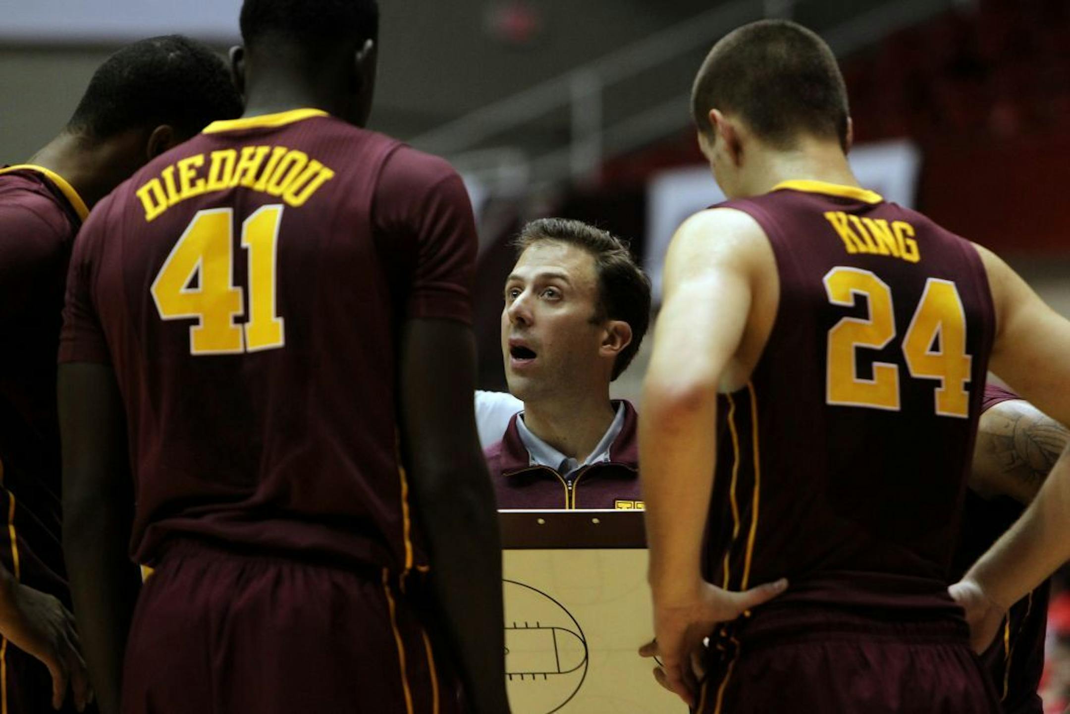 Minnesota university basketball coach Richard Pitino, center, talk to his players .