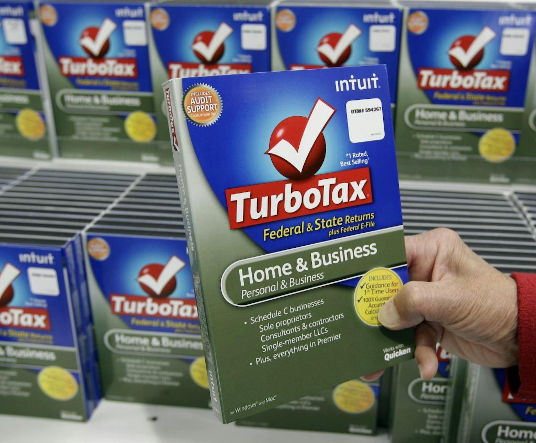 FILE - In this Jan. 24, 2013 file photo, a customer looks at a copy of TurboTax on sale at Costco in Mountain View, Calif. TurboTax says it has temporarily stopped processing state tax returns due to an increase in fraudulent fillings. Intuit, the company behind the popular tax preparation software, says state tax returns already filed since Thursday, Feb. 5, 2015, will be transmitted as soon as possible. Users can still submit their federal income tax returns.