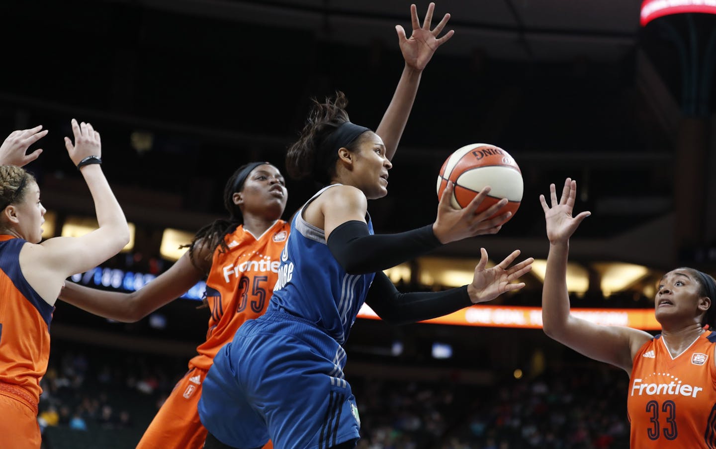 Minnesota Lynx forward Maya Moore (23) scored over Connecticut Sun forward Jonquel Jones (35) and Morgan Tuck (33) at Xcel Energy Center May 22, 2017 in St. Paul, MN.