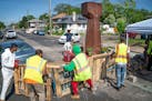 A crew from Agape arrives at George Floyd Square in June and attempts to remove shipping pallets placed on 38th Street to block traffic.