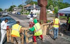 A crew from Agape arrives at George Floyd Square in June and attempts to remove shipping pallets placed on 38th Street to block traffic.
