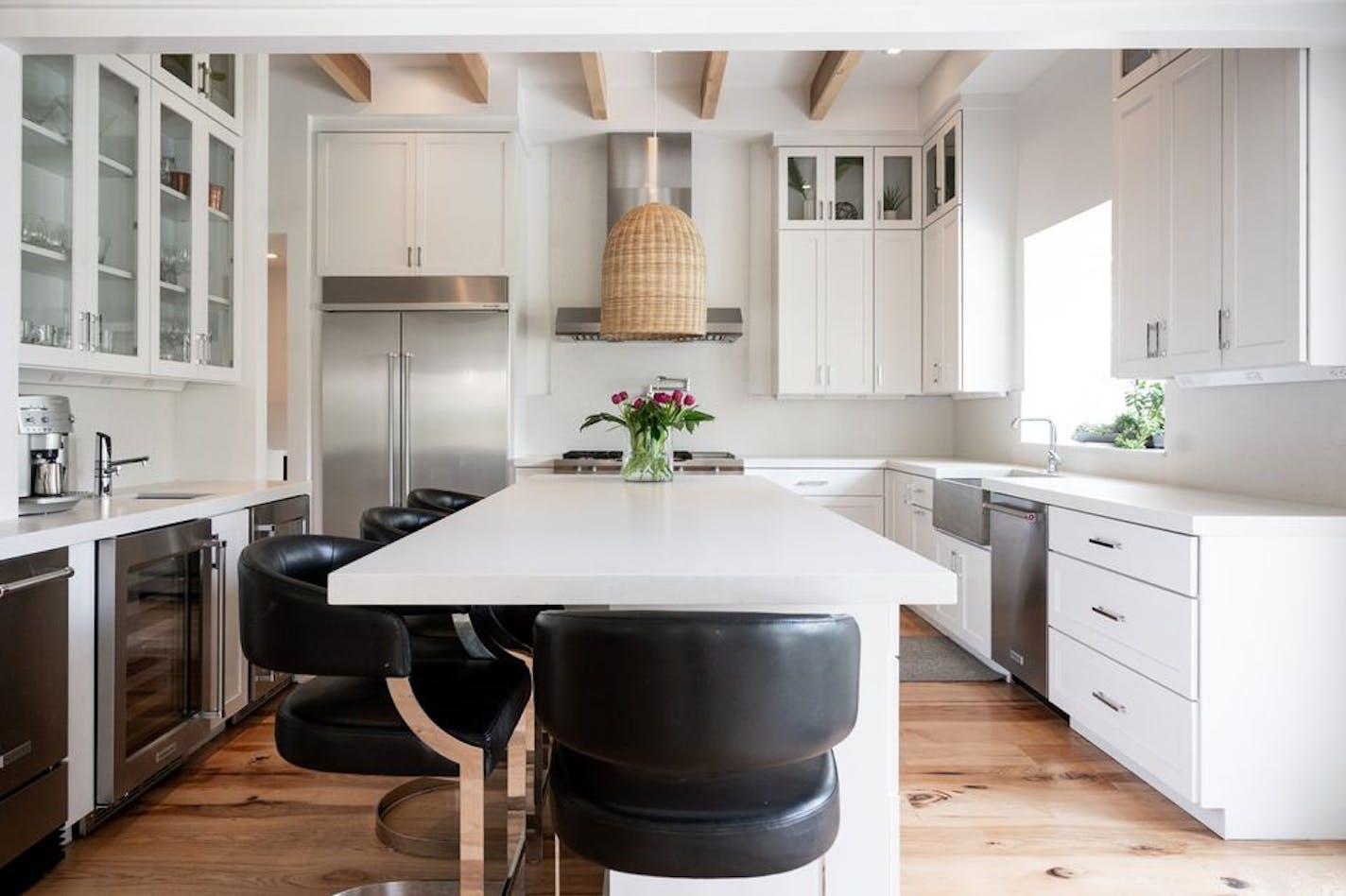 The kitchen is newly remodeled, featuring a lofted ceiling, Caesarstone quartz counters, custom cabinetry and premium appliances.