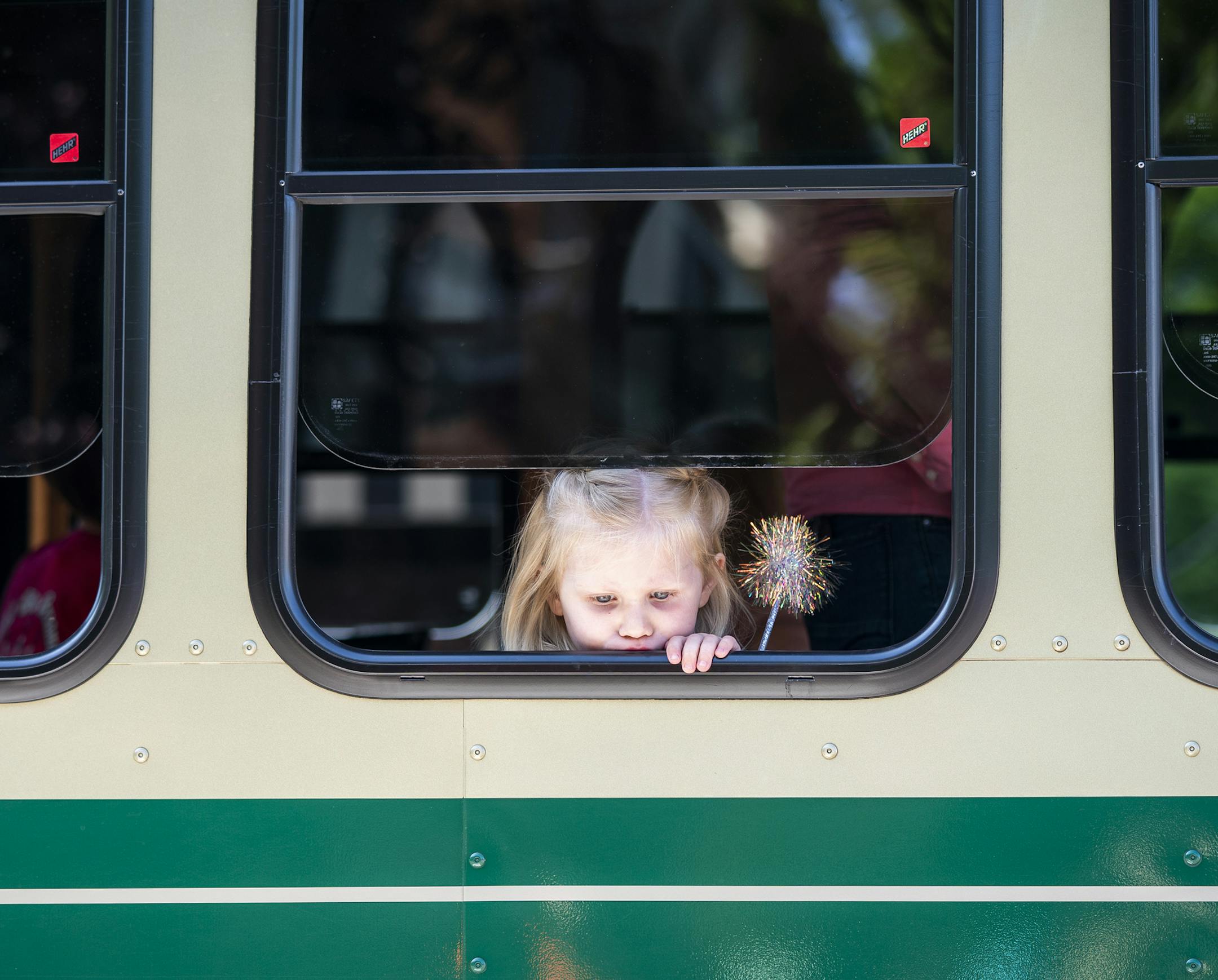 A girl peeks out the window as she rides in the parade on the Grand Ole Creamery trolley. ] LEILA NAVIDI &#xa5; leila.navidi@startribune.com BACKGROUND INFORMATION: The Grand Old Day 2019 Parade in St. Paul on Sunday, June 2, 2019.
