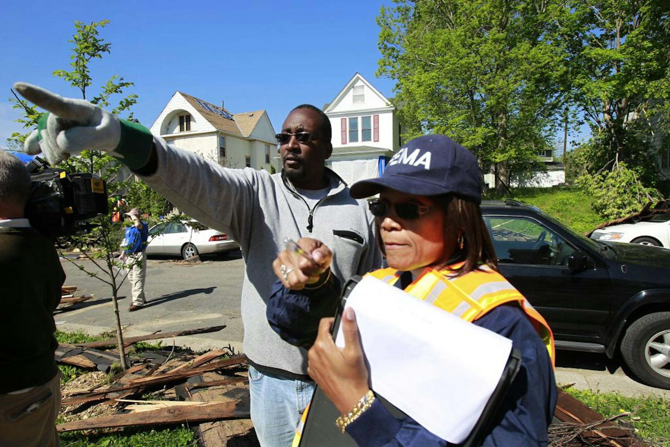 Homeowner Alto Richardson, left, talked with FEMA agent Deborah Bivens during an assessment of his home on the 2200 block of Russell Av. N.