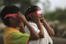 Indian children watch a partial solar eclipse in Hyderabad, India, Wednesday, March 9, 2016 Indian people in northeast and eastern coastal strip of th