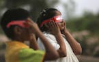 Indian children watch a partial solar eclipse in Hyderabad, India, Wednesday, March 9, 2016 Indian people in northeast and eastern coastal strip of th