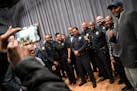 Booker T. Hodges, front right of center, takes a photo with a group of Black members of law enforcement, first responders and community activists befo