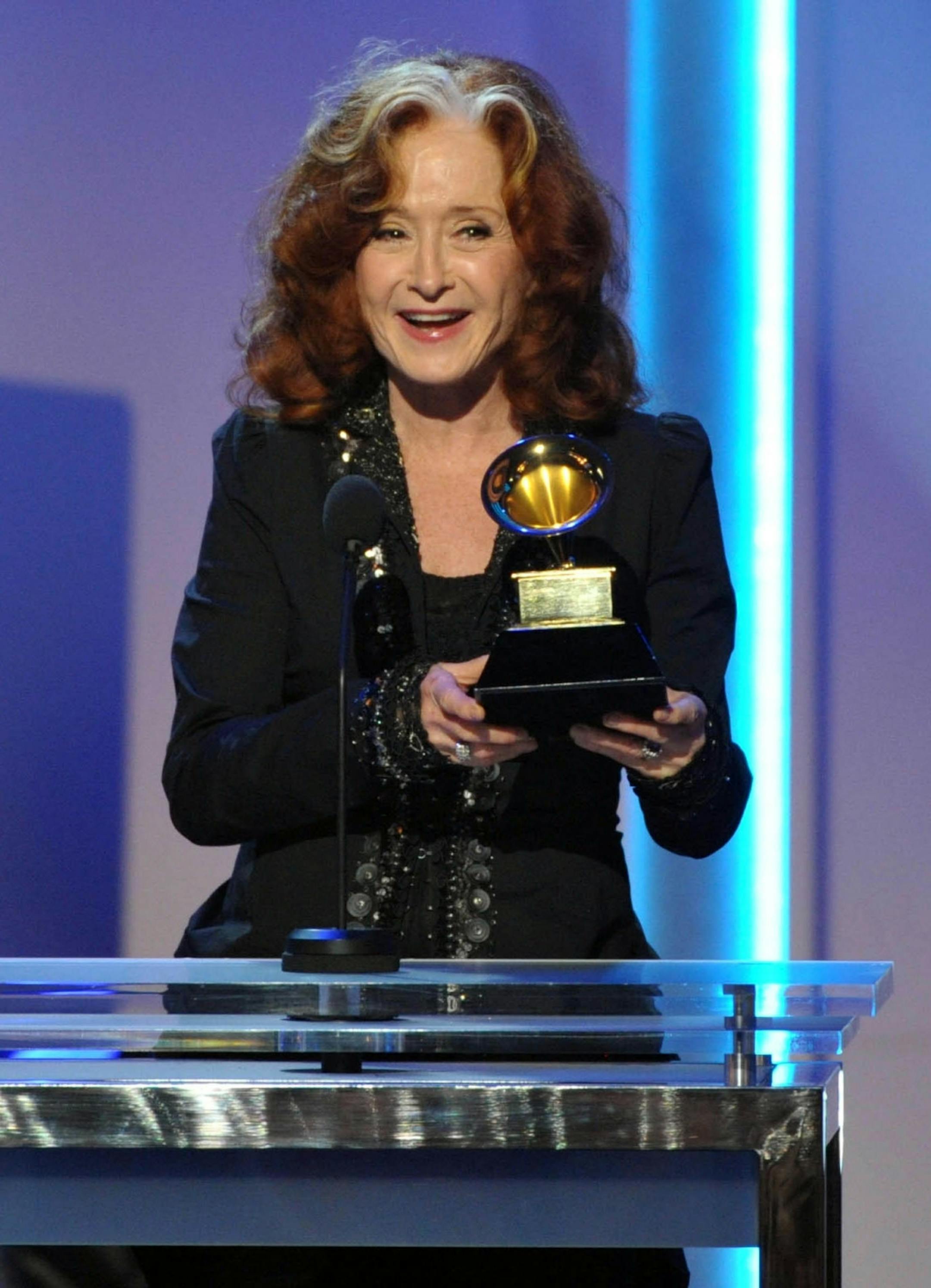 Bonnie Raitt accepts the award for best Americana album for "Slipstream" during the pre-telecast at the 55th annual Grammy Awards on Sunday, Feb. 10, 2013, in Los Angeles.