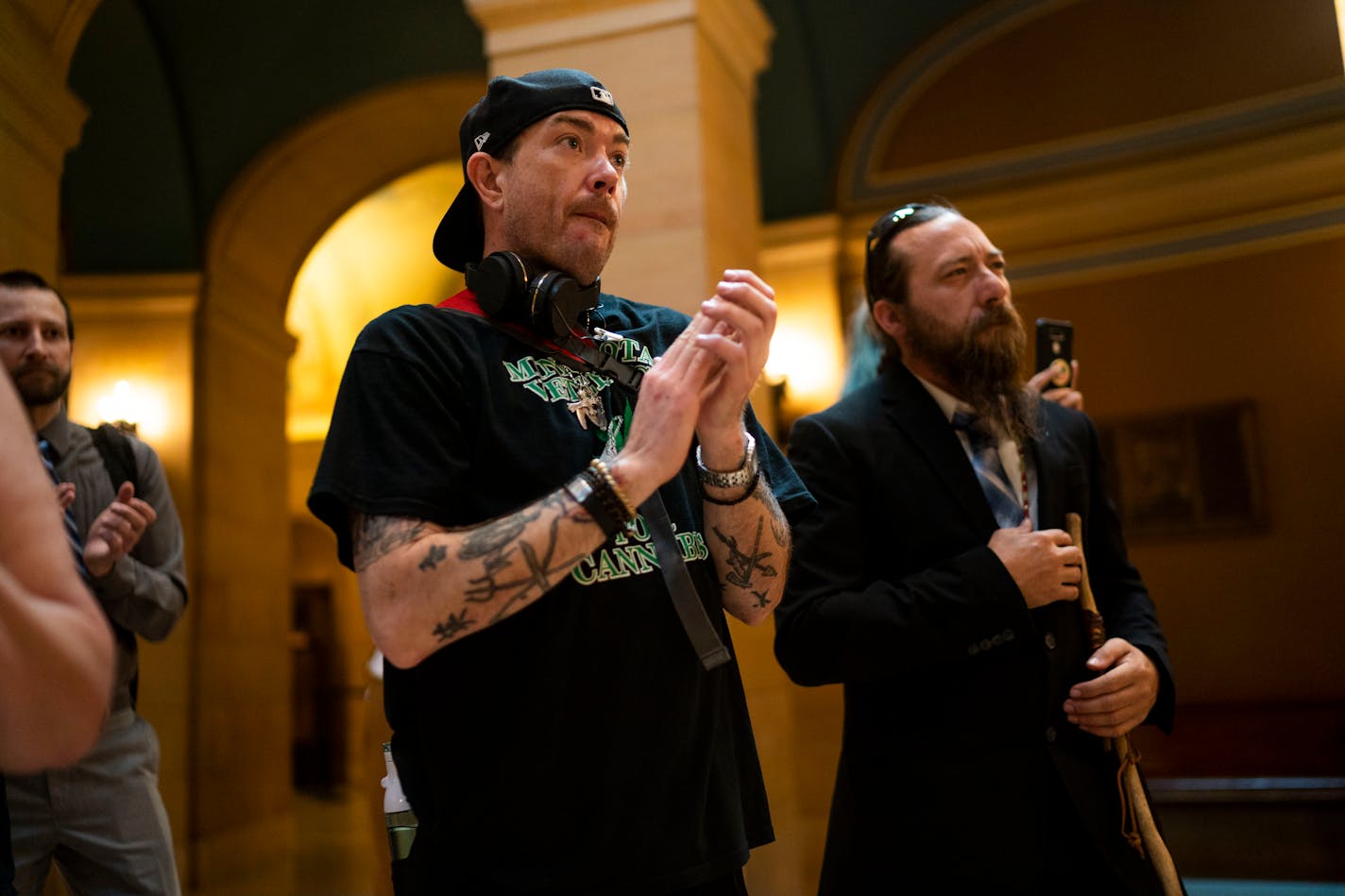 Kevin Bjerke, left, and John Jones, right, listen to politicians and local marijuana advocates speak to media in support for several marijuana proposals at the Minnesota State Capitol on Wednesday, June 16, 2021, in St. Paul. Bjerke, a marijuana activist since 1997, works with Minnesota Veterans for Cannabis. ] ANTRANIK TAVITIAN • anto.tavitian@startribune.com